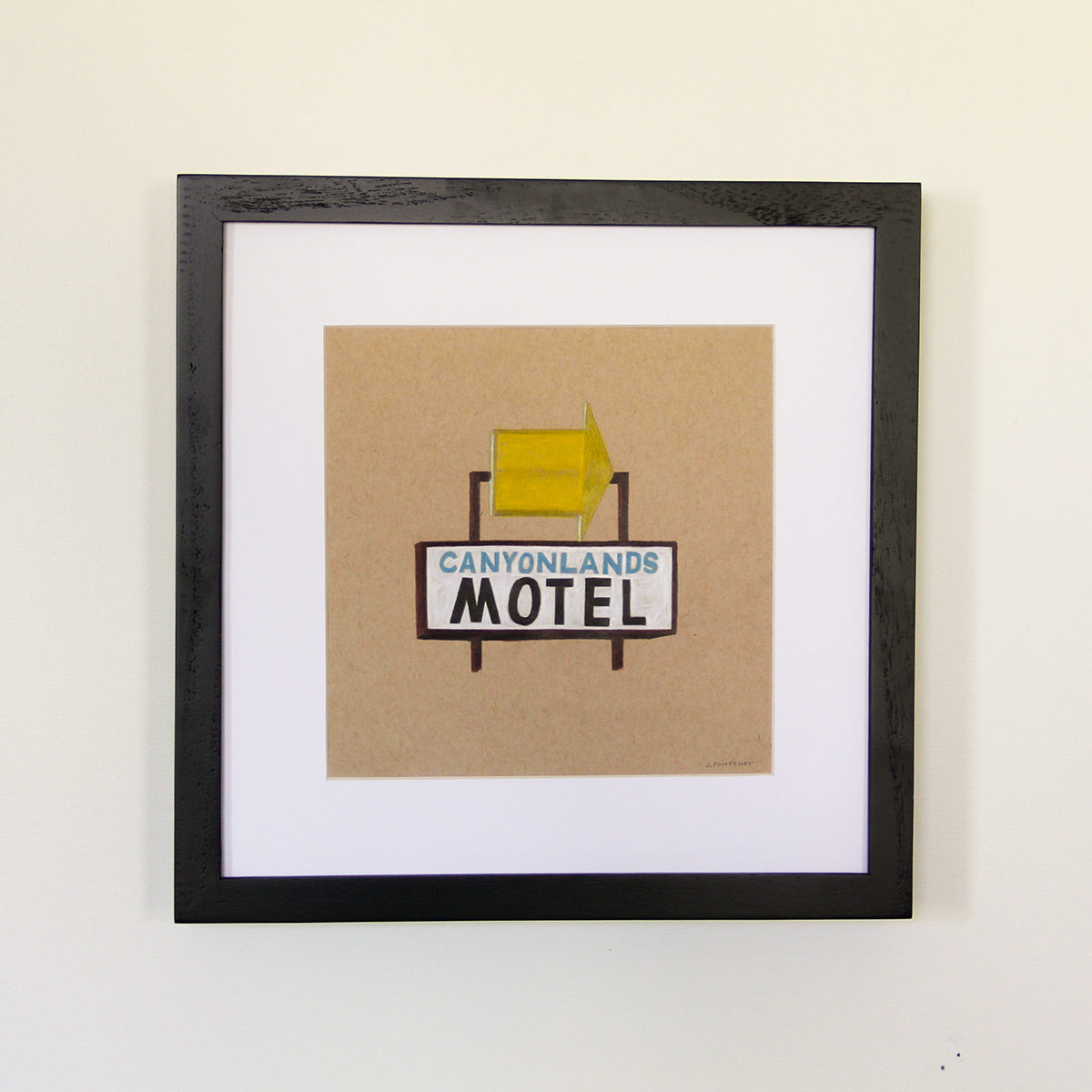 Framed artwork hung on white wall. Colored pencil drawing on tan toned paper of a yellow and light blue motel road sign with a 2 inch white matte around the art in a black wood frame.