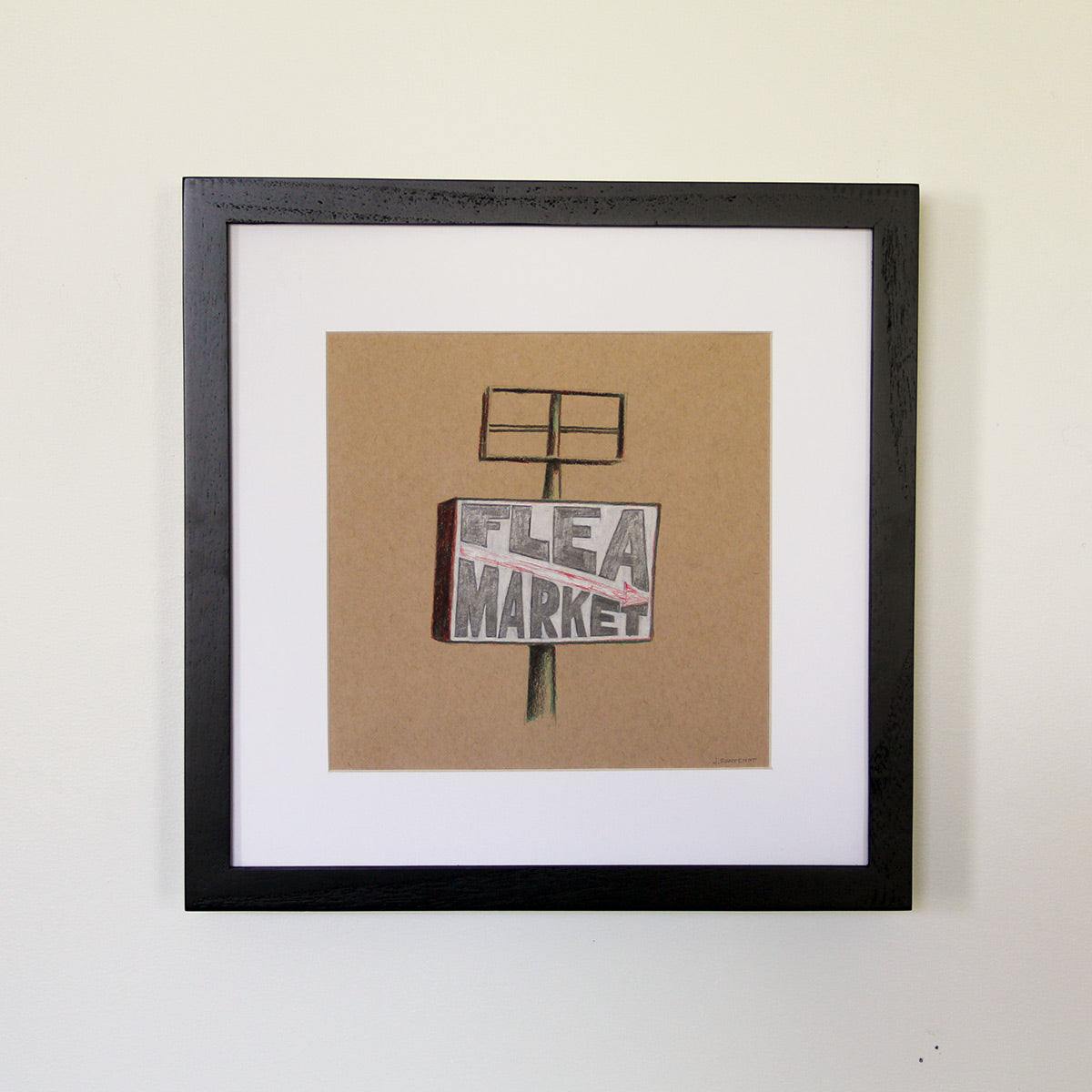 Framed artwork hung on white wall. Colored pencil drawing on tan toned paper of a black and white "Flea Market" road sign with a 2 inch white matte around the art in a black wood frame.