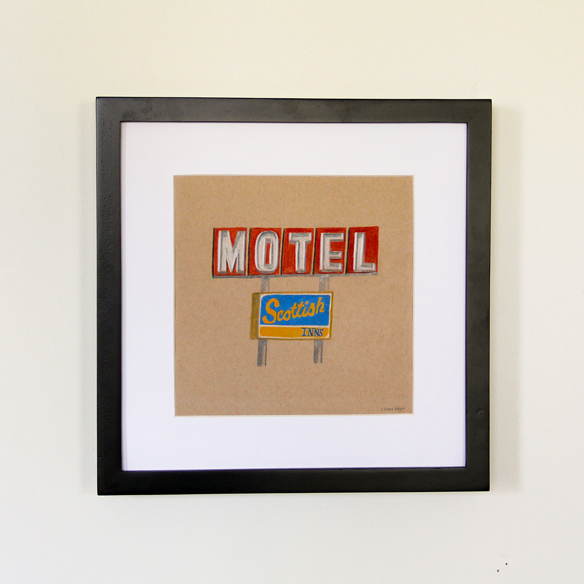 Framed artwork hung on white wall. Colored pencil drawing on tan toned paper of a motel road sign with a 2 inch white matte around the art in a black wood frame.