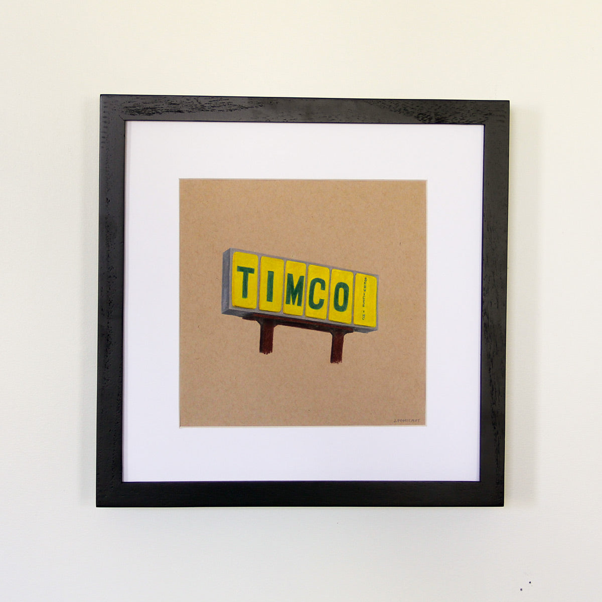 Framed artwork hung on white wall. Colored pencil drawing on tan toned paper of a yellow and green road sign with a 2 inch white matte around the art in a black wood frame.