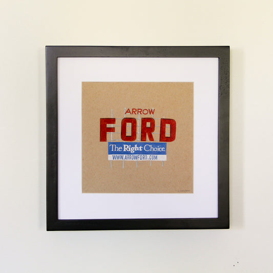 Framed artwork hung on white wall. Colored pencil drawing on tan toned paper of a red, blue and white road side sign with a 2 inch white matte around the art in a black wood frame.