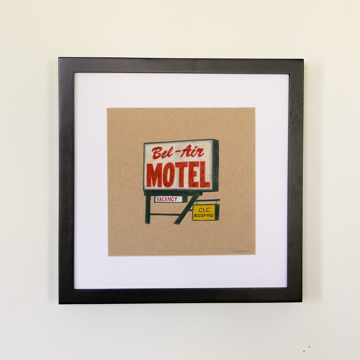 Framed artwork hung on white wall. Colored pencil drawing on tan toned paper of a red and green motel road sign with a 2 inch white matte around the art in a black wood frame. 