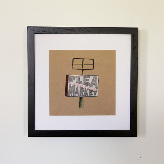 Framed artwork hung on white wall. Colored pencil drawing on tan toned paper of a black and white "Flea Market" road sign with a 2 inch white matte around the art in a black wood frame. 