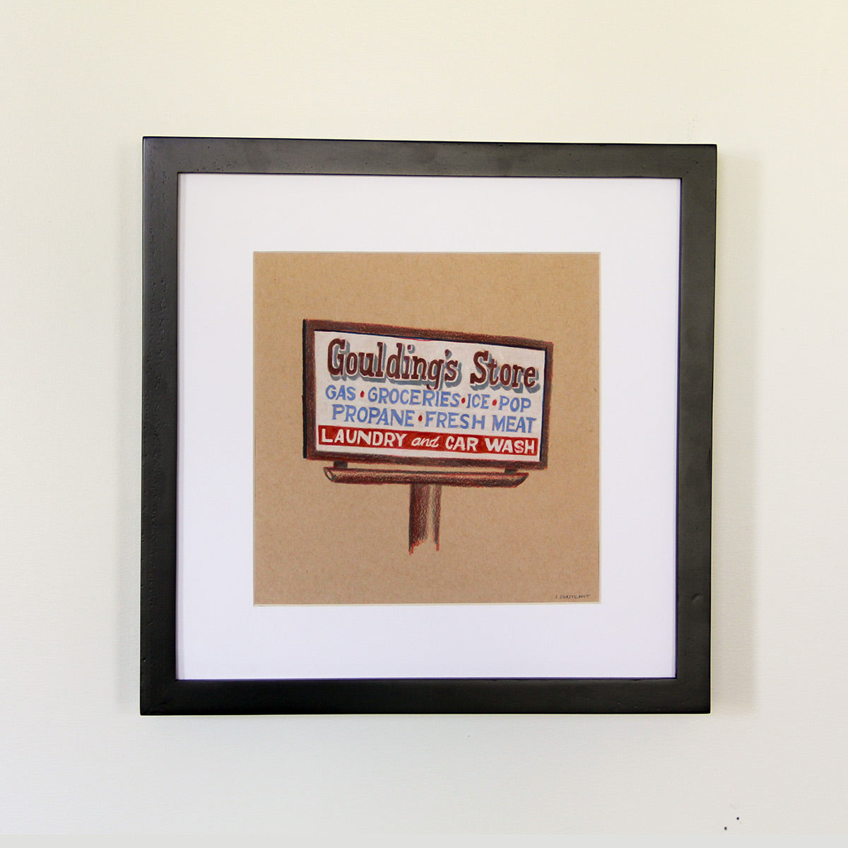 Framed artwork hung on white wall. Colored pencil drawing on tan toned paper of a brown and white road store sign with a 2 inch white matte around the art in a black wood frame. 