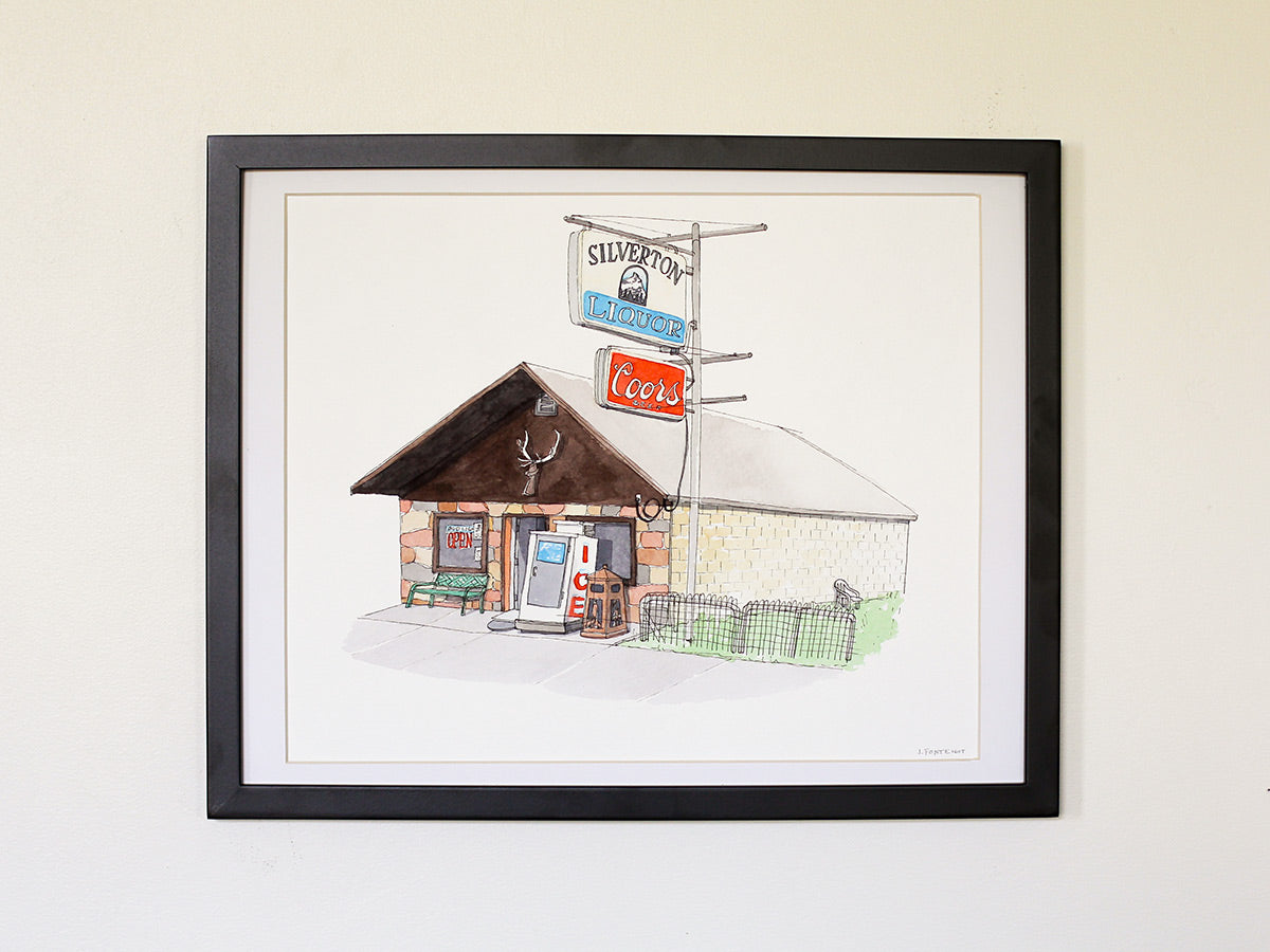 Framed original watercolor art on white wall with black wood frame.